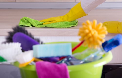 Cleaner wearing PPE while handling carpet cleaning equipment safely